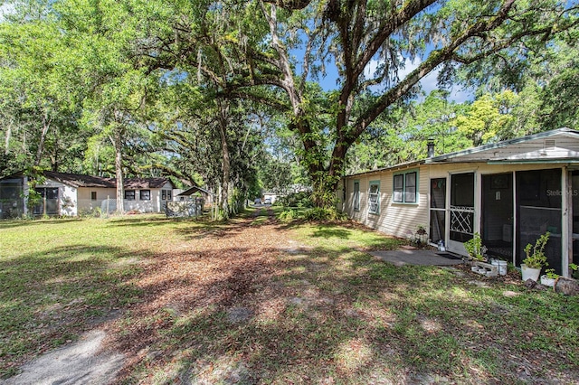 view of yard featuring a sunroom