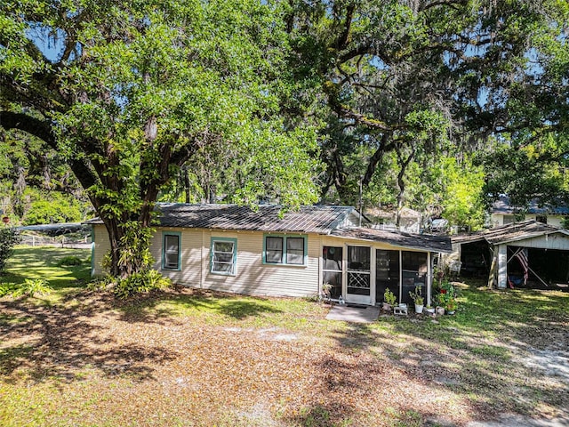 back of property with a sunroom