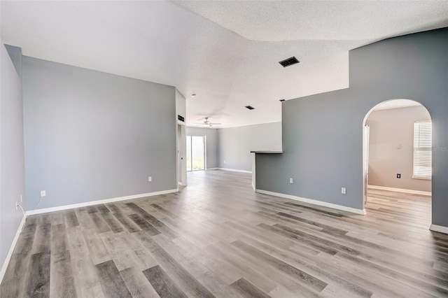 unfurnished room featuring light hardwood / wood-style floors, a textured ceiling, and ceiling fan