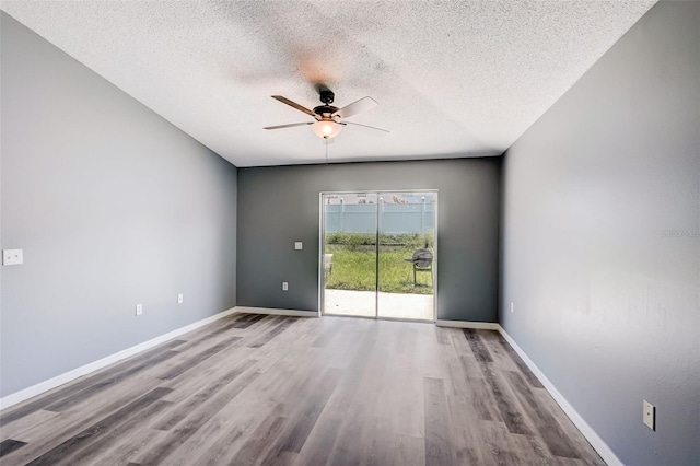 spare room with a textured ceiling, wood-type flooring, and ceiling fan