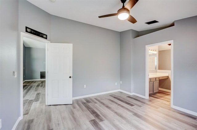 spare room featuring light hardwood / wood-style flooring, ceiling fan, and built in desk