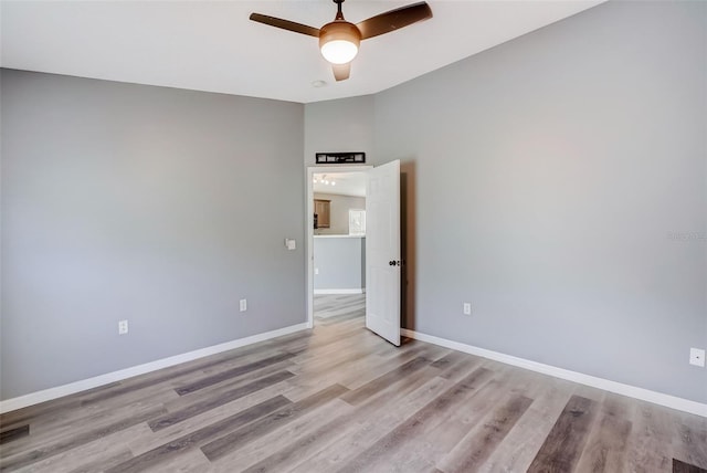 spare room featuring ceiling fan and light hardwood / wood-style flooring