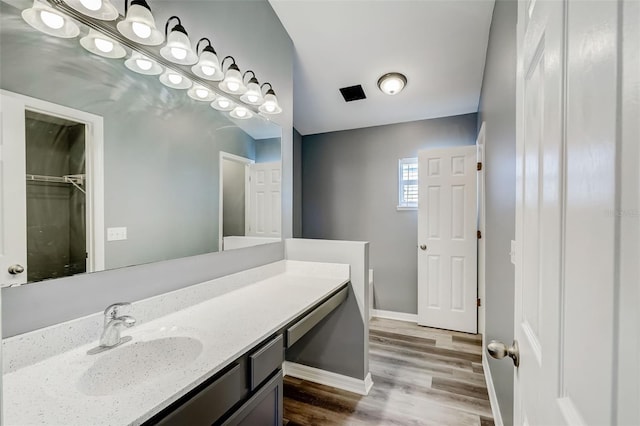 bathroom featuring hardwood / wood-style flooring and vanity