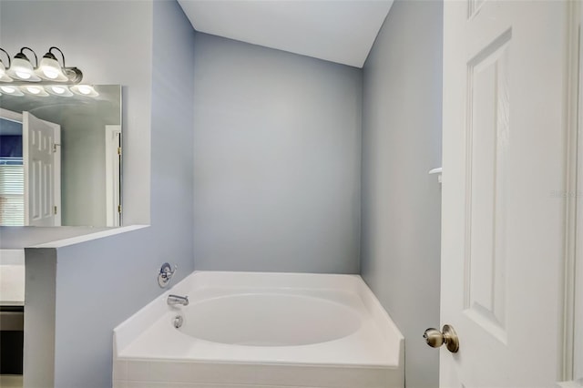 bathroom featuring lofted ceiling and a bathtub