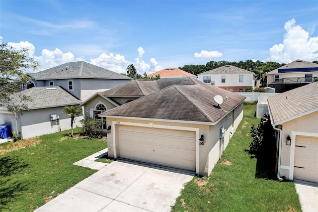 view of front of house with a front yard and a garage