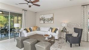 tiled living room with ceiling fan