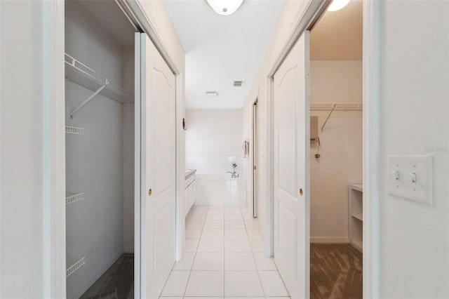 corridor featuring light tile patterned floors