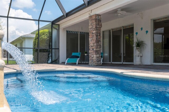 view of pool featuring a lanai and ceiling fan