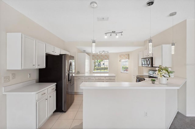 kitchen featuring kitchen peninsula, appliances with stainless steel finishes, light tile patterned floors, white cabinets, and hanging light fixtures