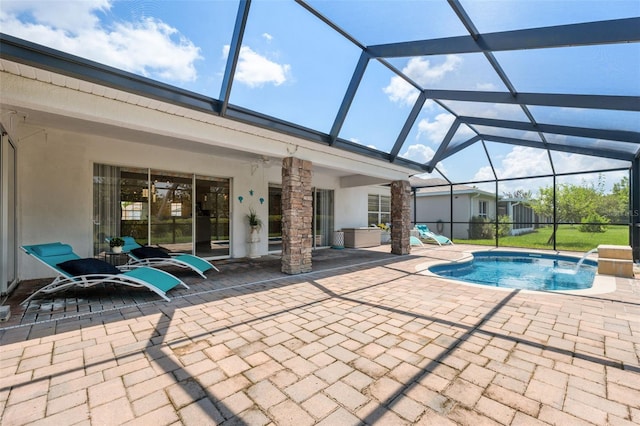 view of swimming pool featuring pool water feature, a patio, ceiling fan, and a lanai