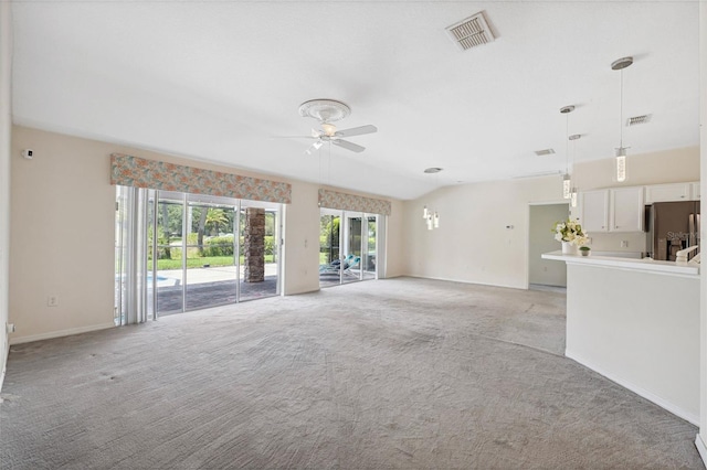 unfurnished living room featuring light carpet, ceiling fan, and lofted ceiling