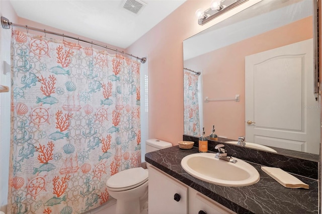 bathroom with a shower with curtain, vanity, and toilet