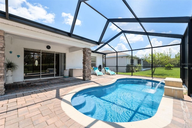 view of pool with a patio area, pool water feature, and glass enclosure