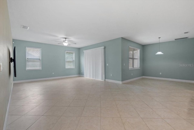 unfurnished room with ceiling fan and light tile patterned floors