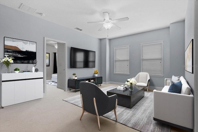 living room with ceiling fan and light colored carpet