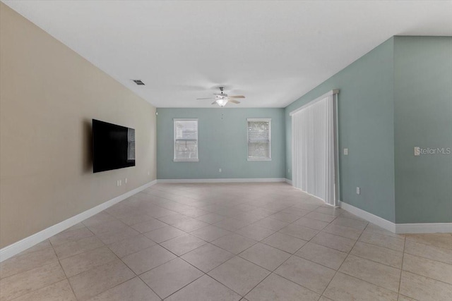 tiled spare room featuring ceiling fan