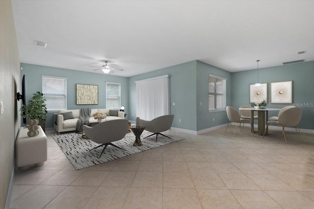 tiled living room featuring ceiling fan