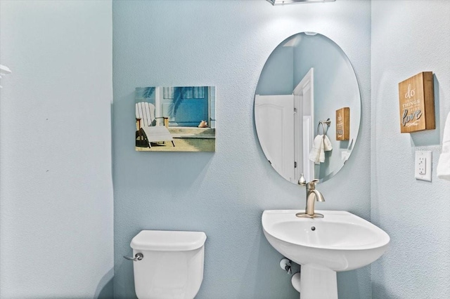 bathroom featuring sink and toilet