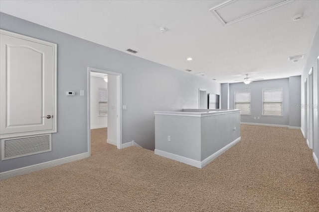 hallway featuring light colored carpet