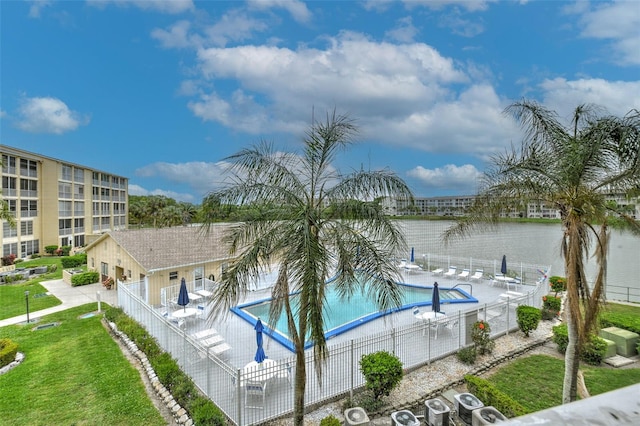 view of pool featuring a water view, a yard, and a patio