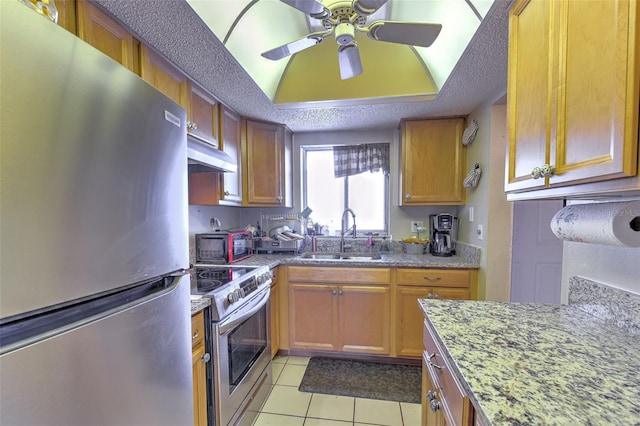 kitchen with a textured ceiling, appliances with stainless steel finishes, sink, ceiling fan, and light tile patterned floors