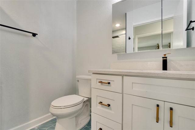 bathroom featuring vanity, tile floors, and toilet