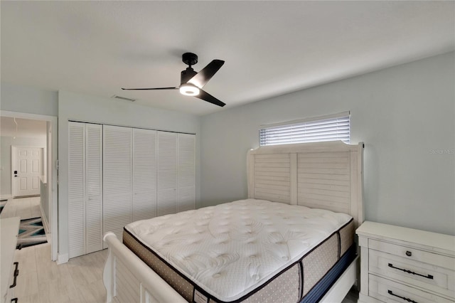 bedroom with a closet, ceiling fan, and light wood-type flooring