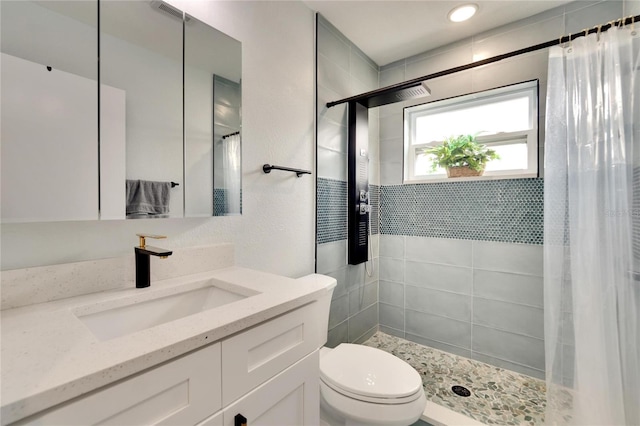 bathroom featuring a shower with shower curtain, toilet, and vanity