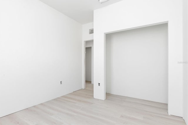 unfurnished bedroom featuring light wood-type flooring