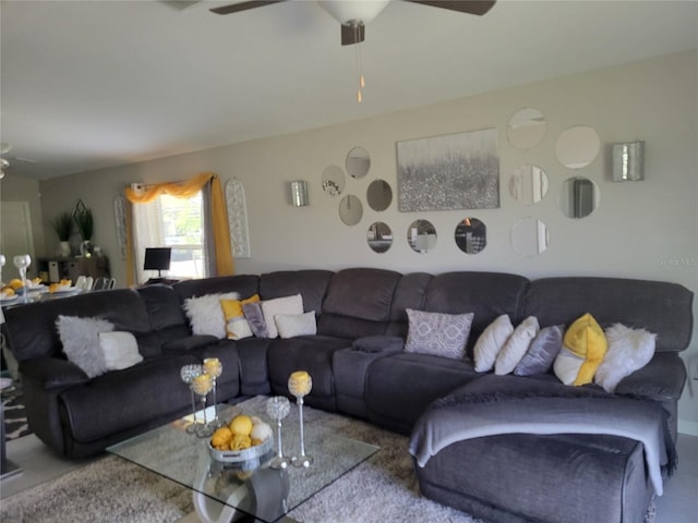 carpeted living room with ceiling fan