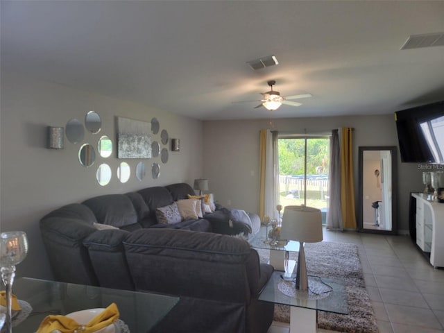 tiled living room with ceiling fan