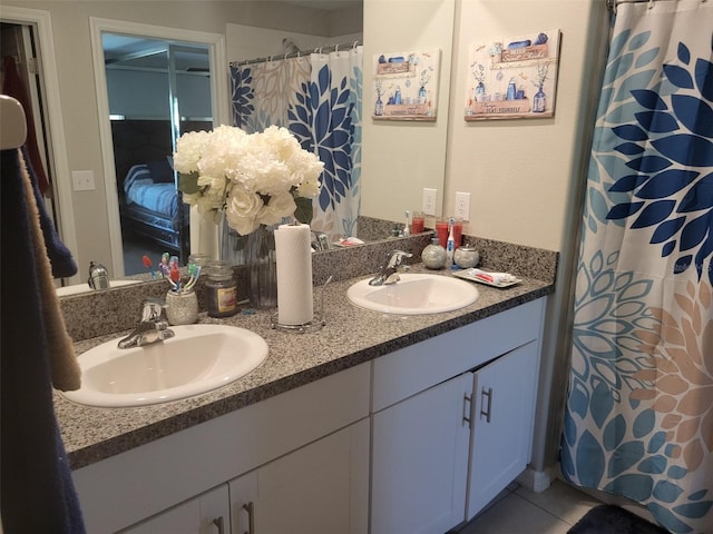 bathroom featuring tile flooring and dual bowl vanity