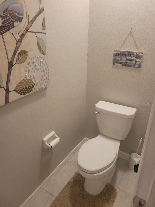 bathroom featuring toilet and tile floors