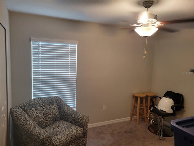 living area featuring ceiling fan and carpet floors