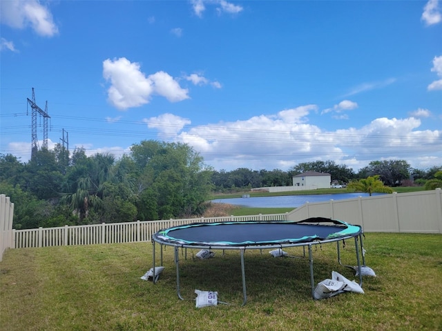 view of pool with a yard and a trampoline