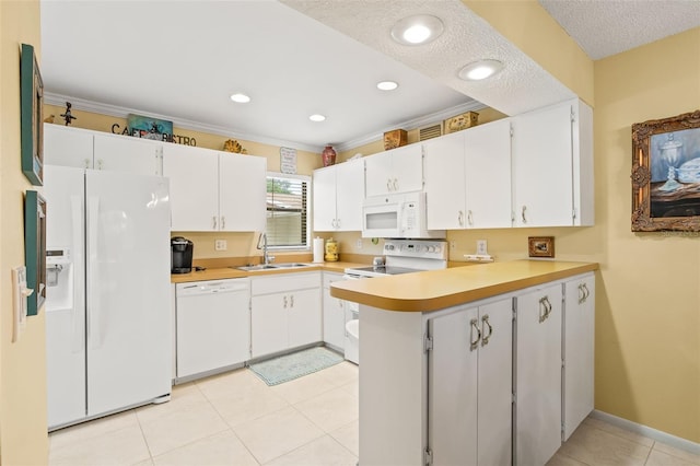 kitchen with white cabinets, white appliances, light tile floors, sink, and a textured ceiling