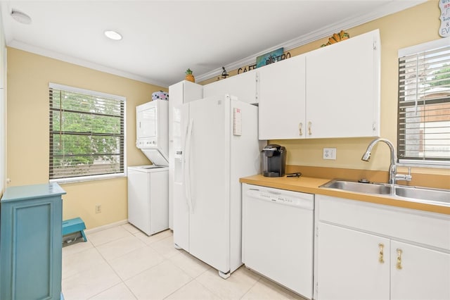 kitchen featuring white cabinets, white appliances, a healthy amount of sunlight, and light tile floors