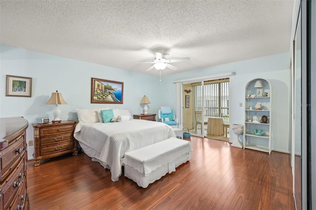 bedroom featuring ceiling fan, dark hardwood / wood-style floors, and a textured ceiling