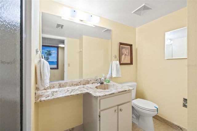 bathroom with tile flooring, oversized vanity, and toilet