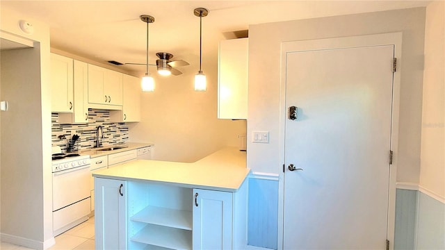 kitchen featuring white cabinetry, sink, ceiling fan, white range oven, and pendant lighting