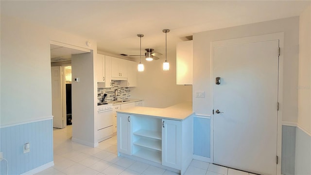 kitchen featuring ceiling fan, sink, white range, decorative light fixtures, and white cabinets