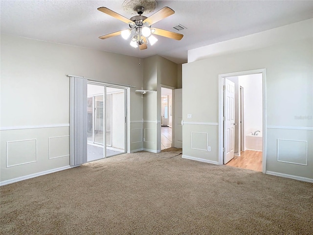 interior space with ceiling fan, light colored carpet, and a textured ceiling