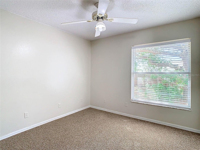 carpeted spare room with ceiling fan and a textured ceiling