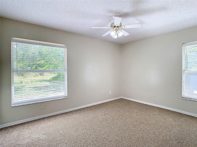 empty room featuring a textured ceiling, ceiling fan, and carpet flooring