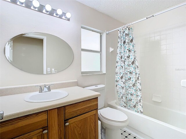 full bathroom with vanity, toilet, shower / tub combo, and a textured ceiling