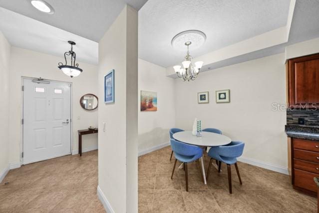 tiled dining area with an inviting chandelier