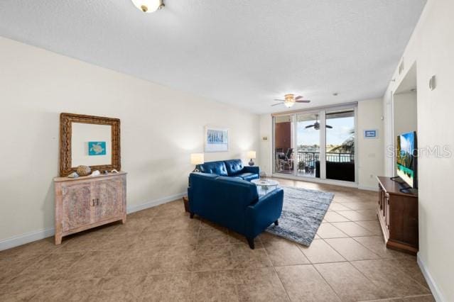 living room with ceiling fan and light tile floors