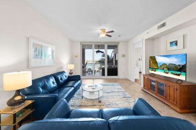 living room with ceiling fan and light tile floors