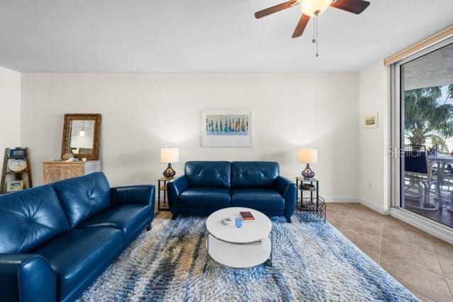 tiled living room featuring ceiling fan