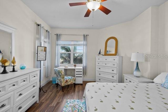 bedroom with ceiling fan and dark wood-type flooring